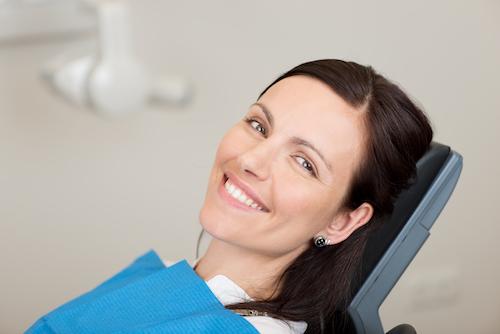 Woman smiling in treatment chair at dentist in Bonita Springs FL